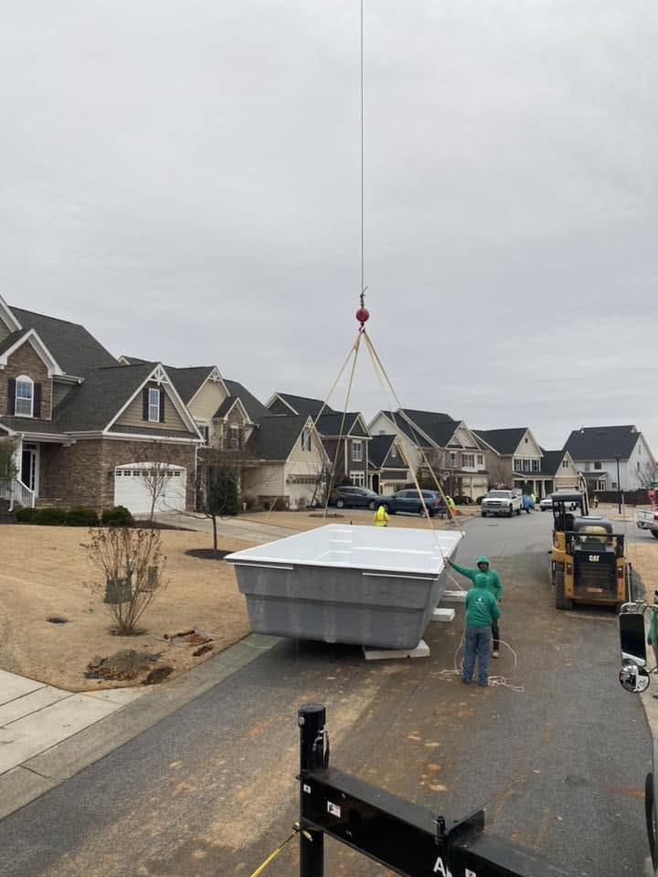 setting pool in residential backyard with crane 2